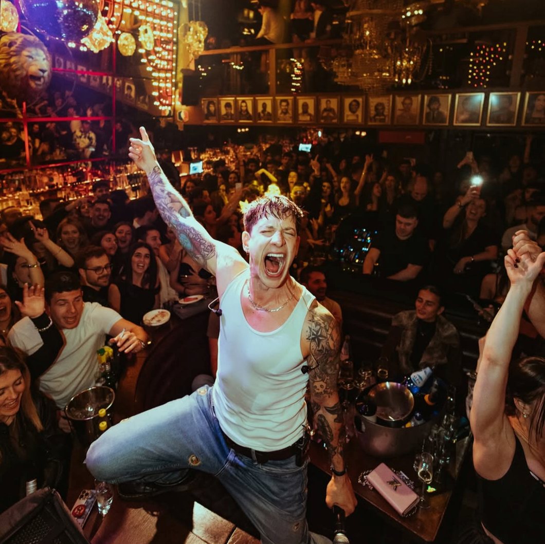 Ilias Bogdanos on stage, crowd behind him